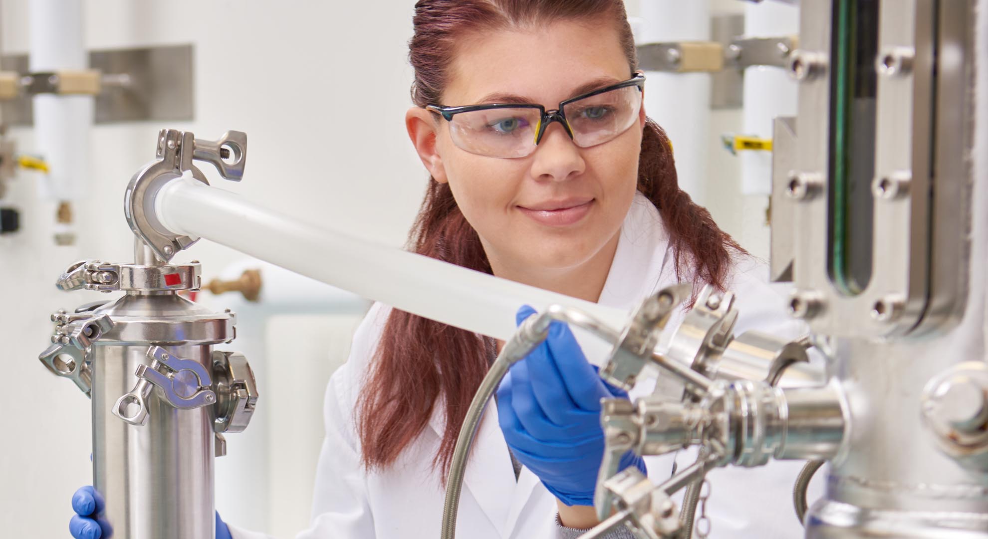 Lab technician with bioreactor